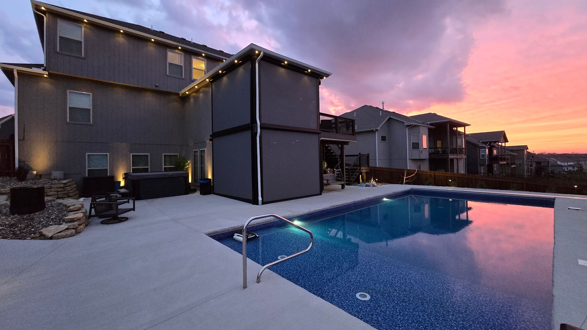 Motorized exterior window shades at sunset