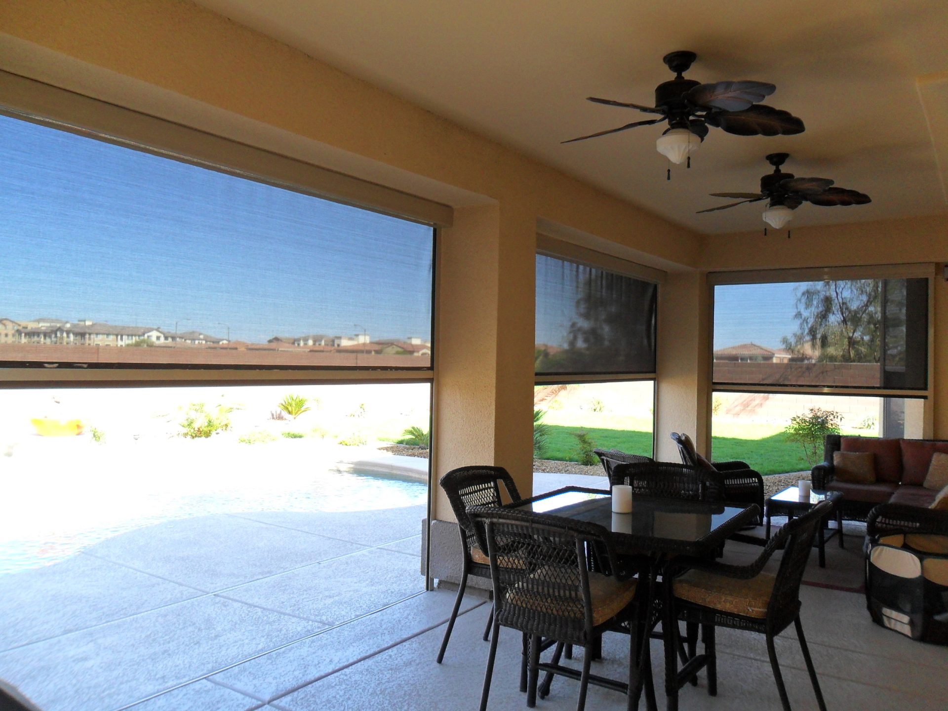 Outdoor patio with tables and ceiling fans