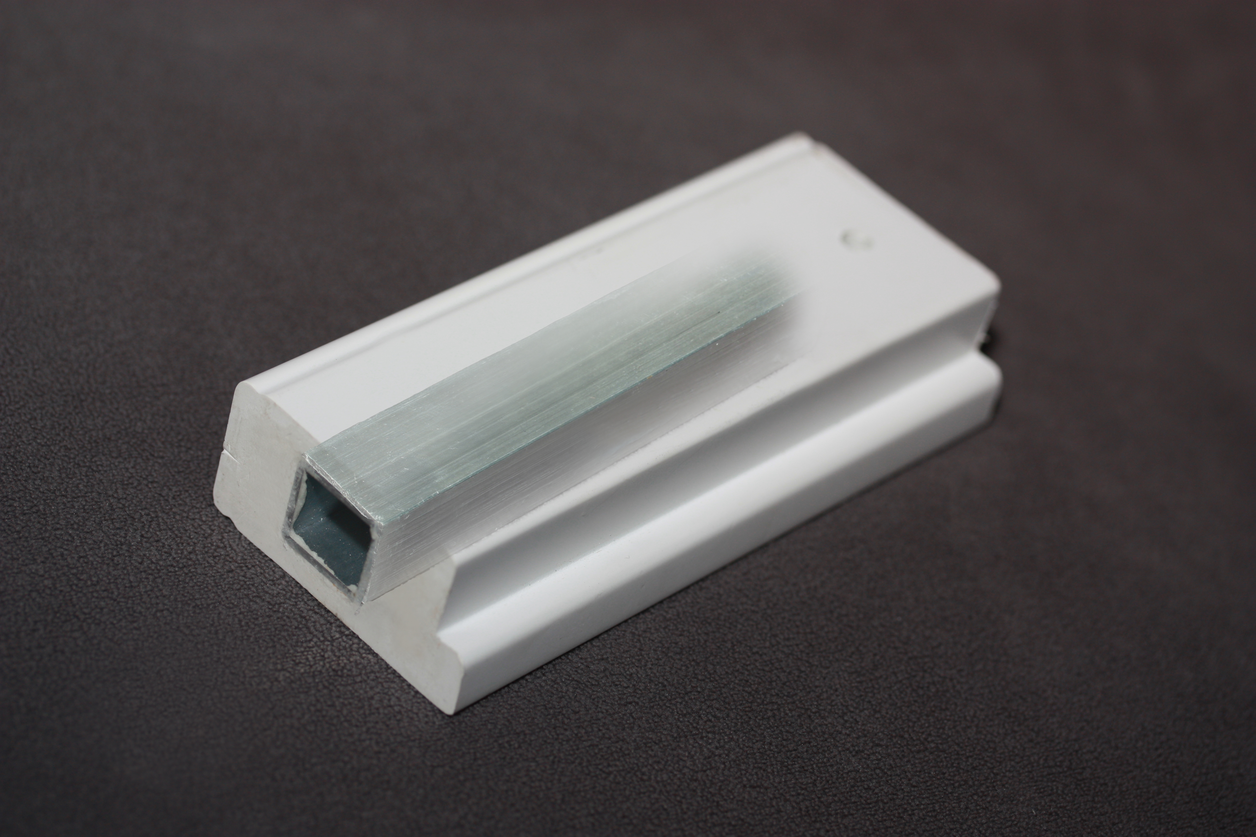 AlumaCore detail — aluminum reinforcement core embedded inside the shutter louver and stile